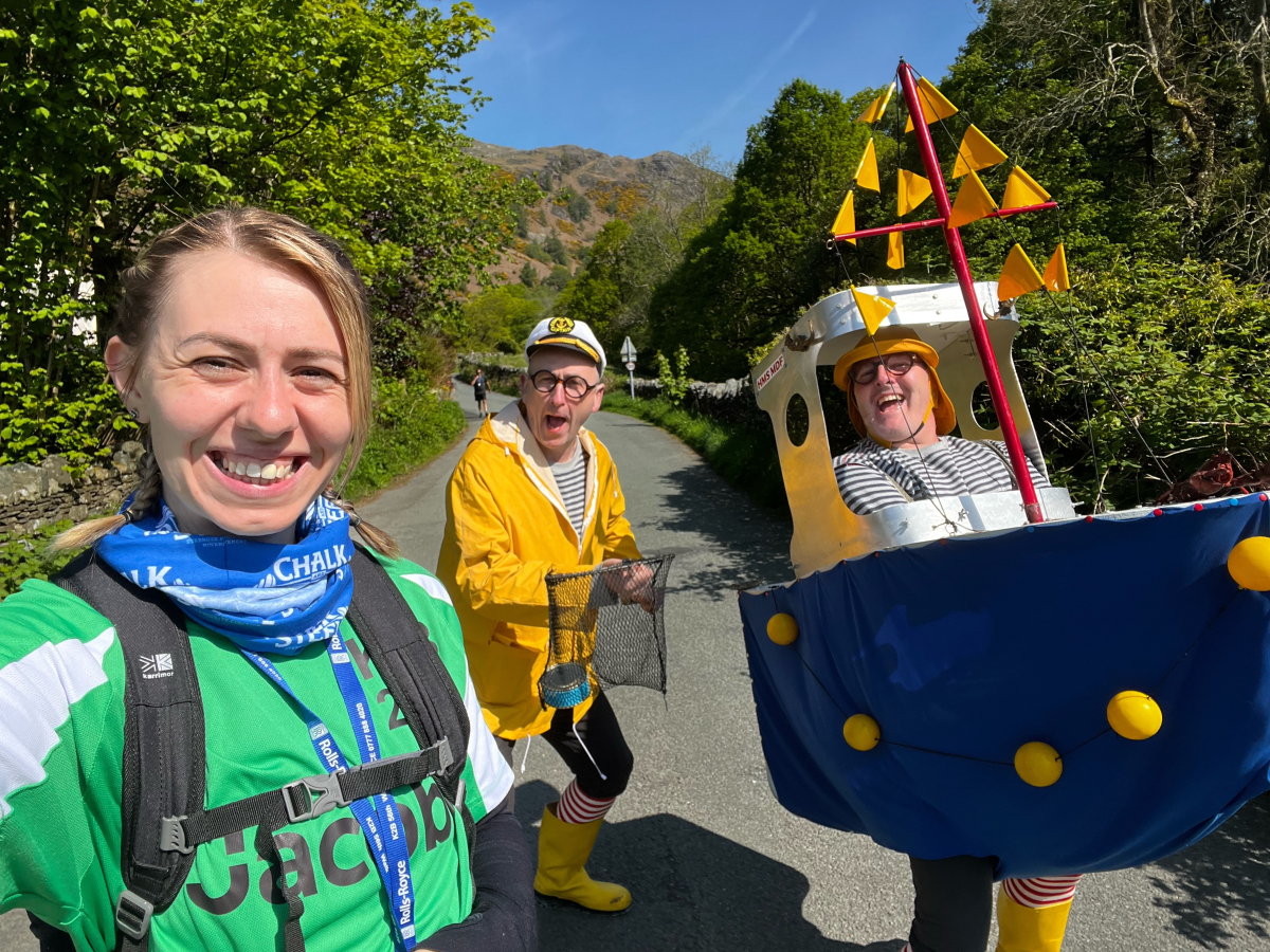 Three walkers, including a man in a boat costume, and one in a fisherman costume